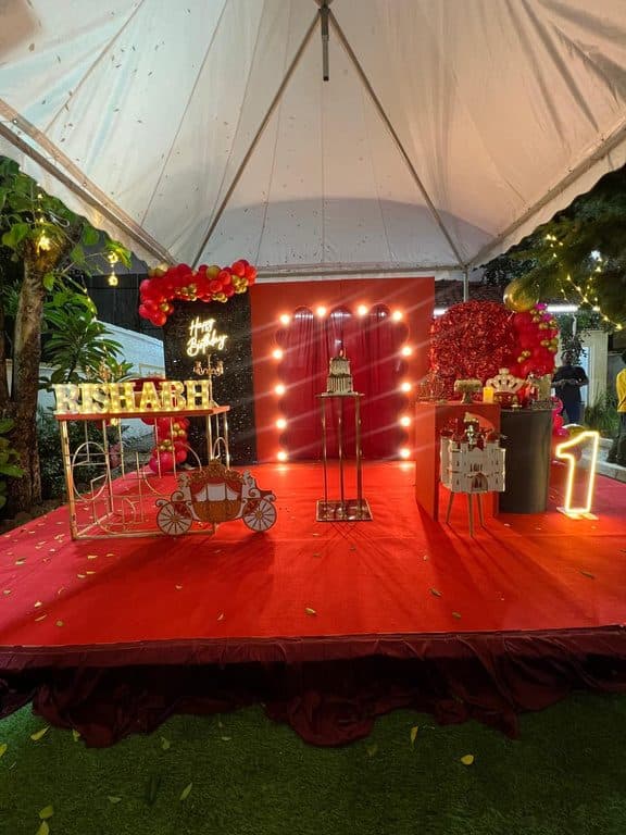 Red-lit birthday stage at night