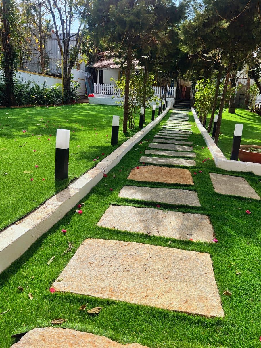 Stone pathway across the lawn at Earthen Courtyard